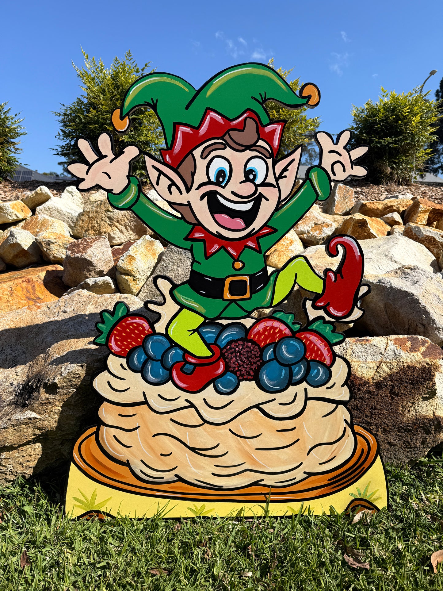 Elf jumping out of Pavlova Christmas
