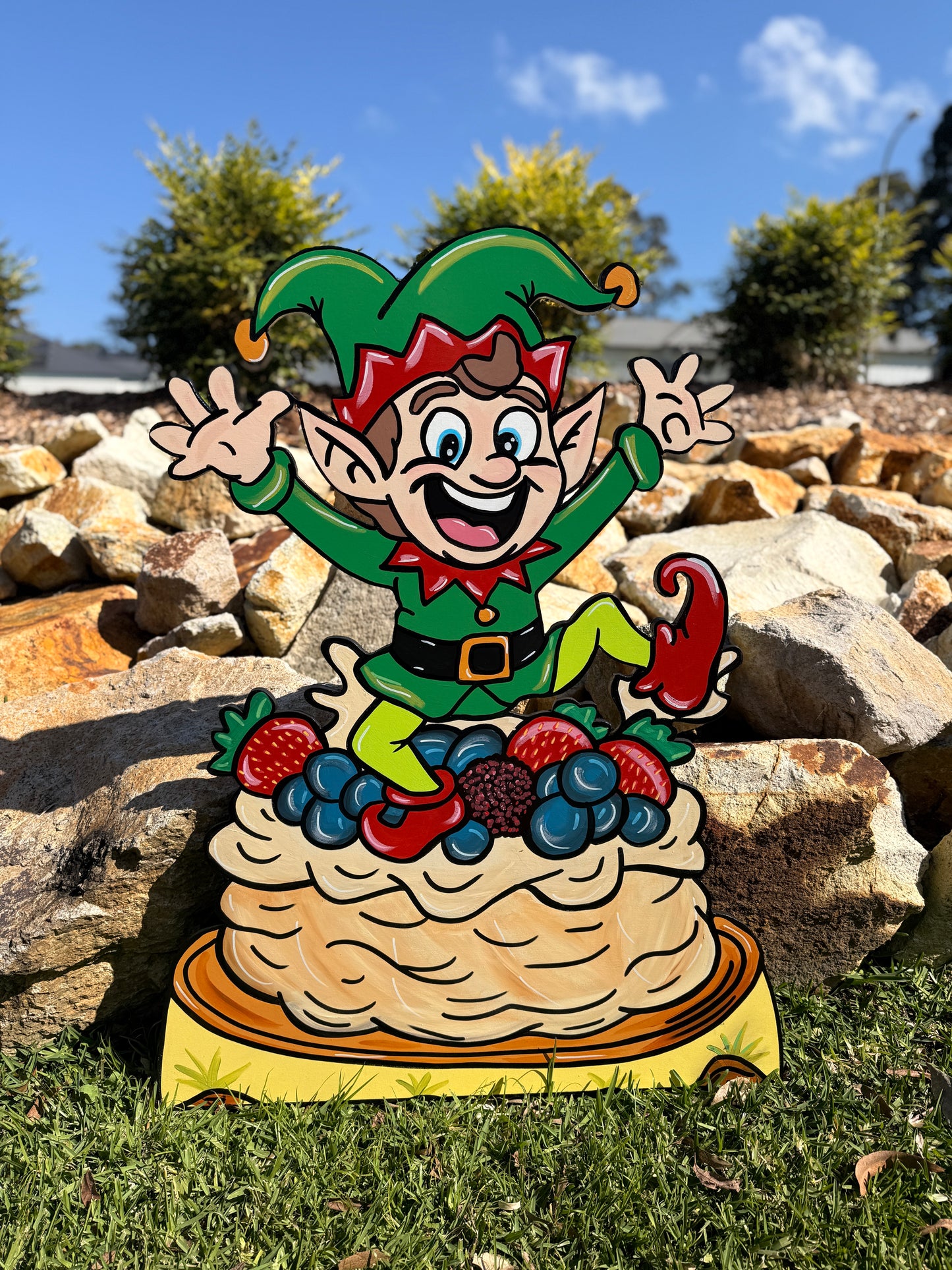 Elf jumping out of Pavlova Christmas